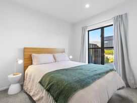 A bedroom with a bed and bedside table at Te Ohu - Wanaka Holiday Home, Wanaka