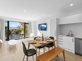 A dining room with a table and chairs at Te Ohu - Wanaka Holiday Home in Wanaka