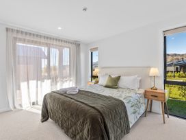A bedroom with a bed and nightstands at Cromwell Holiday Home in Cromwell