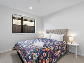 A bedroom with a bed and bedside table at Cromwell Holiday Home in Cromwell