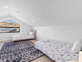 A bedroom with two beds and a window at Cromwell Holiday Home in Cromwell