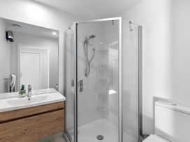 A bathroom with a shower and sink at Cromwell Holiday Home in Cromwell