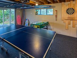 A game room with a ping pong table and foosball table at La Maison Bleu - Mangawhai Heads Holiday Home, Mangawhai