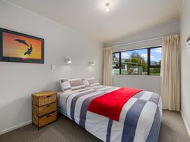A bedroom with a bed and window view at Picton Holiday Home in Picton