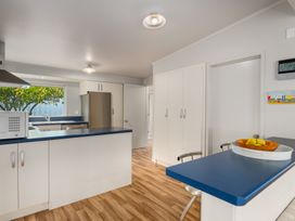 A kitchen with a countertop and refrigerator at Picton Holiday Home in Picton