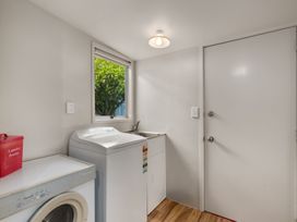 A laundry room with a washing machine and sink at Picton Holiday Home in Picton