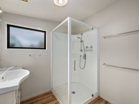 A bathroom with a shower and sink at Picton Holiday Home in Picton