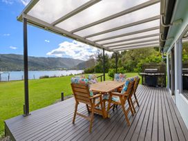 An outdoor patio with seating and a table at Picton Holiday Home in Picton