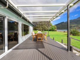 An outdoor dining area with a table and chairs at Picton Holiday Home in Picton
