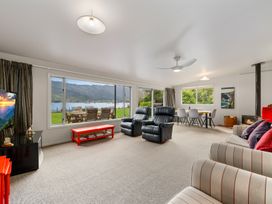 A living room featuring sofas and a dining area at Picton Holiday Home in Picton