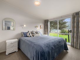 A bedroom with a bed and bedside table at Picton Holiday Home Picton