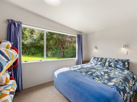 A bedroom with a bed and a bunk bed at Picton Holiday Home in Picton