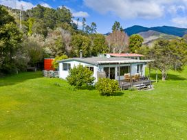 A house with a deck and garden at Picton Holiday Home in Picton