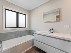 A bathroom with a bathtub and a sink at Turangi Holiday Home in Turangi
