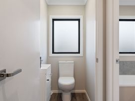 A bathroom with a toilet and a sink at Turangi Holiday Home in Turangi