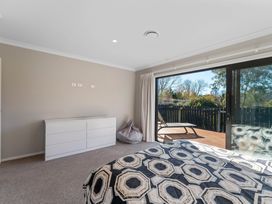 A bedroom with a bed and dresser at Turangi Holiday Home in Turangi