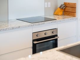 A kitchen with an oven and cooktop at Turangi Holiday Home in Turangi