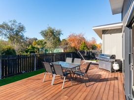 An outdoor dining area with a table and chairs at Turangi Holiday Home in Turangi