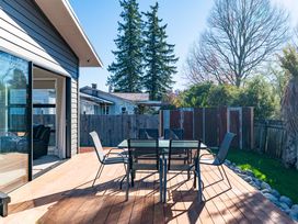An outdoor patio with a table and chairs at Turangi Holiday Home Turangi