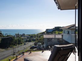 A view of the sea and houses from a terrace at Bay View Escape - Cable Bay