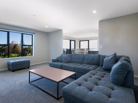 A living room with a sofa and coffee table at Bay View Escape - Cable Bay