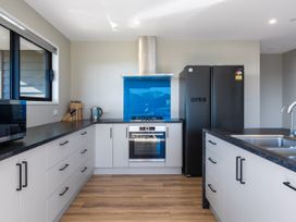 A kitchen with an oven and sink at Bay View Escape - Cable Bay