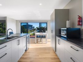A kitchen with sink and dishwasher at Bay View Escape - Cable Bay