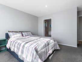 A bedroom with a bed and doorway at Bay View Escape - Cable Bay