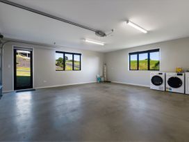 A laundry room with washing machine and dryer at Bay View Escape - Cable Bay