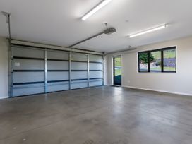 A garage with a door and window at Bay View Escape - Cable Bay