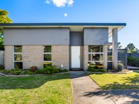 A house with a front door and windows at Sun & Surf Stay - Papamoa Holiday Home
