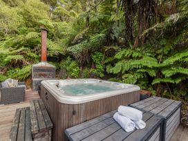 An outdoor area with a hot tub and stove at The Sounds Hideaway - Moetapu Bay