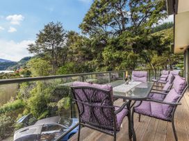 An outdoor seating area with a table and chairs at The Sounds Hideaway - Moetapu Bay