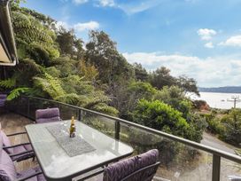 An outdoor area with a table and chairs at The Sounds Hideaway - Moetapu Bay