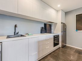 A kitchen with a sink and refrigerator at The Sounds Hideaway - Moetapu Bay