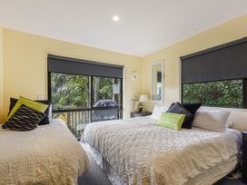 A bedroom with two beds and a lamp at The Sounds Hideaway - Moetapu Bay
