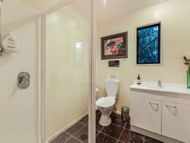 A bathroom with a shower, toilet, and sink at The Sounds Hideaway - Moetapu Bay