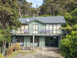 A house with a balcony and satellite dish at The Sounds Hideaway - Moetapu Bay