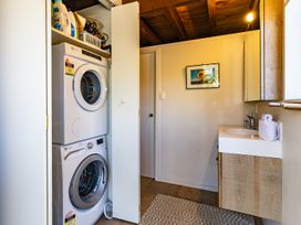A laundry room with washing machine and dryer at Scottbase - Waimarino Holiday Home