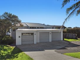 A front view of a house with a garage and driveway at Ocean Breeze Escape - Ohope Holiday Home