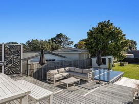 An outdoor space with a couch and table at Ocean Breeze Escape - Ohope Holiday Home