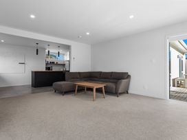 A living room with a sofa and coffee table at Ocean Breeze Escape - Ohope Holiday Home