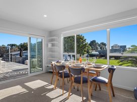 A dining room with a table and chairs at Ocean Breeze Escape - Ohope Holiday Home