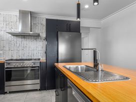 A kitchen with appliances and a sink at Ocean Breeze Escape - Ohope Holiday Home