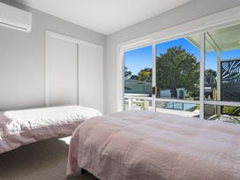 A bedroom with two beds and a window at Ocean Breeze Escape - Ohope Holiday Home
