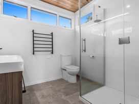 A bathroom with a shower, toilet, and sink at Ocean Breeze Escape - Ohope Holiday Home