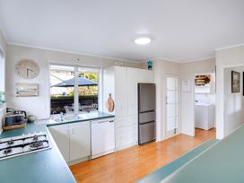 A kitchen with a fridge, stove, and sink at Lola's - Cambridge Holiday Home in Morrinsville