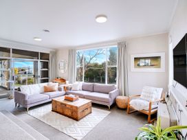 A living room with a sofa and coffee table at Lola's - Cambridge Holiday Home in Morrinsville