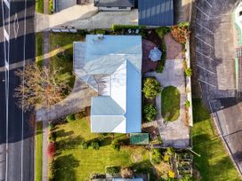 An aerial view of a house with a garden and parking at Lola's - Cambridge Holiday Home, Morrinsville