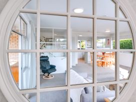 A living room with a window and dining area at Lola's - Cambridge Holiday Home, Morrinsville